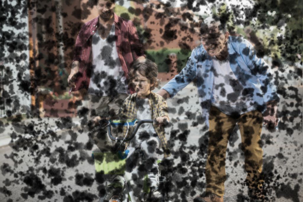 Otrok se vozi s kolesom, pogled je prekrit s številnimi temnimi lisami (simulacija diabetične retinopatije).